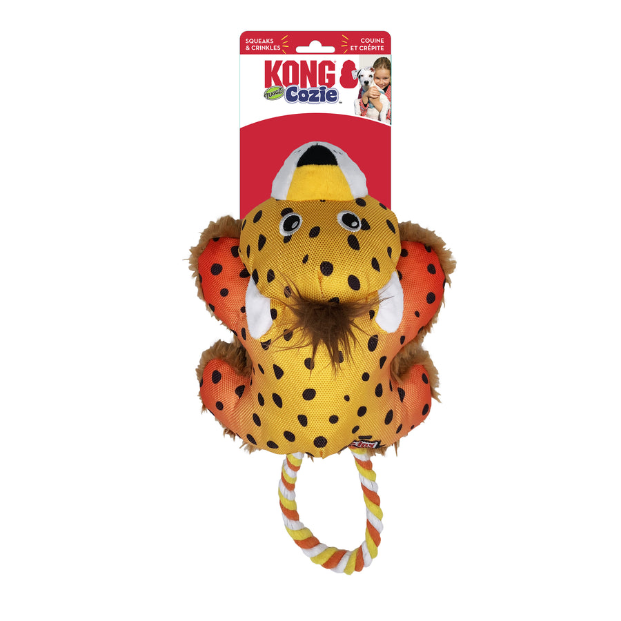 KONG Cozie Tuggz Cheetah dog toy in its original packaging. The plush toy is yellow with black spots, orange accents on the limbs, and a soft brown mane. It has embroidered eyes and ears. A twisted rope handle in yellow, orange, and white extends from the bottom for tugging play. The packaging features the KONG Cozie logo, a red background.