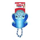 KONG Cozie Tuggz Frog dog toy in its original packaging. The plush toy is blue with dark blue spots, soft limbs, and a smiling face with round black eyes. It has a durable, features a sturdy twisted rope handle in blue and white for interactive tugging play. The packaging highlights the toy’s squeaking and crinkling features.