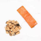 Badlands Ranch Freeze-Dried Superfood Bites Salmon Dog Treats Pile and a salmon
