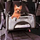 Bergan Booster Soft Pet Carrier is being used in the car. The strap is over the headrest of the car seat. A small dog is sitting inside the carrier, with their head and front legs popped out the top of the carrier.
