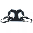 Close up of harness. Showing padded center piece. Adjustable straps on both sides. In the center shows a pinch buckle open and two D rings for leash attachment.