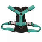 Close up of underside of harness. Showing padded center piece, with center strap attaching the head strap and body strap. D ring in the center for leash attachment. Showing two pinch buckles with reflective material on front.