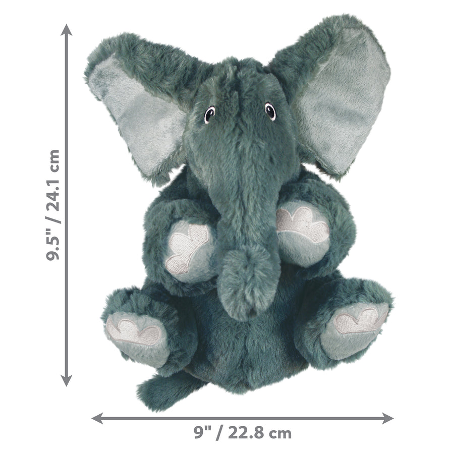 A KONG Comfort Kiddos Elephant plush dog toy with soft, fuzzy fabric. The toy features large floppy ears, embroidered paw details, small black eyes, and a slightly curved trunk. The image includes dimension markers indicating that the toy measures 9.5 inches (12.7 cm) in height and 9 inches (22.8 cm) width.