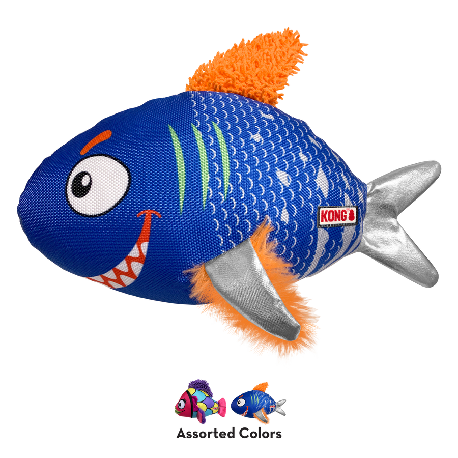 A KONG Reefz dog toy shaped like a playful fish. The toy has a blue fabric body with white scale patterns, a cartoonish face featuring large eyes and a toothy grin, and green gill-like accents. It has silver fabric side fins, an orange plush-textured tail, and matching orange fuzzy side fins. A small KONG logo tag is attached to the side. Below the main toy, two smaller images showcase alternate color variations, a pink one and a blue one, with the text 'Assorted Colors' indicating multiple design options.