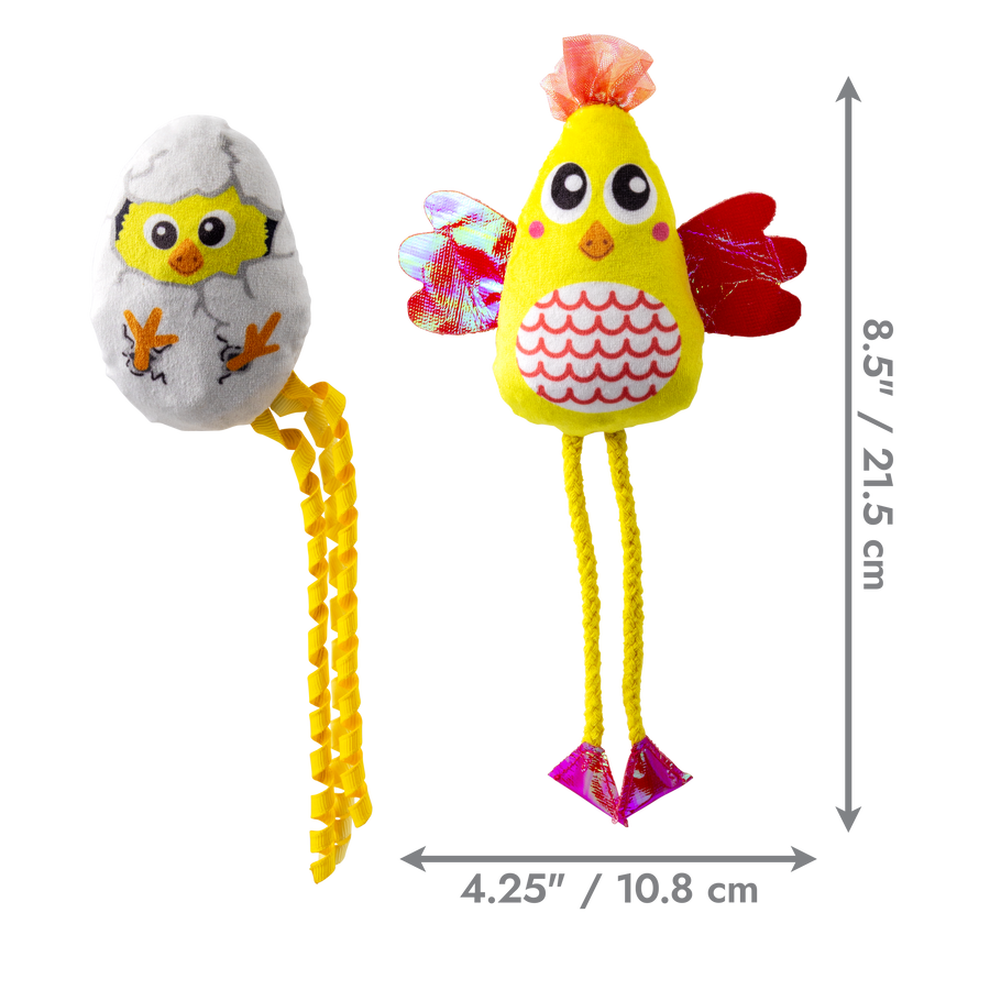 KONG Scrattles Chicken 2-Pack Cat Toy featuring two plush toys: one shaped like a chick emerging from a gray eggshell with dangling yellow ribbon legs, and the other a bright yellow chicken with red wings, pink feet, and patterned belly. Dimensions shown: full chicken toy is 8.5 inches (21.5 cm) tall and 4.25 inches (10.8 cm) wide.