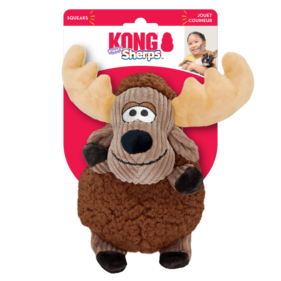 A KONG Sherps Floofs moose plush dog toy in its original packaging. The toy has a round, soft brown fleece-like body with a corduroy-textured tan face. It features embroidered eyes, a black plush nose, and a stitched smile. The moose has large, beige plush antlers, floppy brown arms, and small black hooves. The packaging is red and white, displaying the KONG logo, the words 'Sherps Floofs' in a playful blue and white font, also highlights that the toy squeaks.