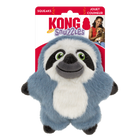 A KONG Snuzzles Kiddos Sloth plush dog toy in its original packaging. The toy is a soft, round, blue-gray sloth with a fuzzy texture. It has a smiling face with embroidered green eyes, a black nose, and a white face framed by dark brown patches. The plush toy also features a white oval patch on its belly and small black paws. The packaging is red and white, displaying the KONG logo, the word 'Snuzzles' in a playful purple font. The packaging also highlights that the toy squeaks.