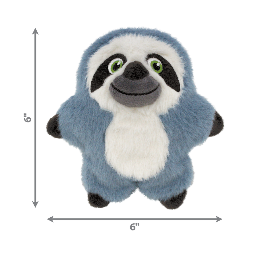 A KONG Snuzzles Kiddos Sloth plush dog toy, measuring 6 inches in both height and width. The toy is a soft, round, blue-gray plush sloth with a fuzzy texture. It has a smiling face with embroidered green eyes, a black nose, and a white face framed by dark brown patches. A white patch is visible on its belly, and its small black paws extend slightly from its round body. The toy appears to be designed for dogs, offering a cuddly and engaging play experience.