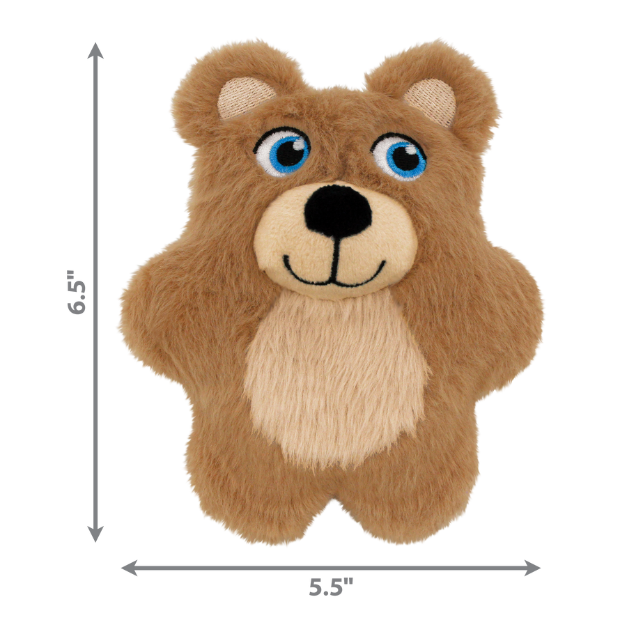 A KONG Snuzzles Kiddos Teddy plush dog toy without packaging. The toy is a small, soft, light brown teddy bear with a fuzzy texture. It has bright embroidered blue eyes, a black nose, and a stitched smiling mouth. A beige patch covers its belly, adding contrast to the brown fur. The dimensions of the toy are labeled on the image, measuring 6.5 inches in height and 5.5 inches in width.
