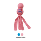 KONG Wubba Puppy Dog Toy in light pink, featuring a durable fabric-covered ball with a smaller ball on top, and long floppy tails for interactive tugging and shaking. The 'KONG Wubba' logo is printed on the fabric, making it an engaging toy designed for puppies. Two small circles indicating product comes in light blue and light pink.