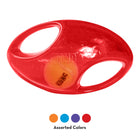 A red KONG Jumbler Football Dog Toy featuring a durable, rubber-like outer shell with two oval cutout handles. Inside the translucent red toy, a smaller orange KONG-branded tennis ball is visible. Below the toy, four color swatches—orange, blue, purple, and red—indicate that the product comes in assorted colors.