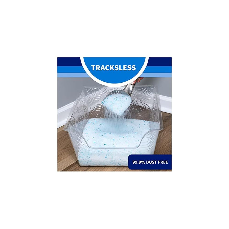Tracksless. Person holding litter scooper while spilling crystal litter into litter box. 99.9% dust free.