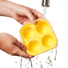 Hand washing Woof Pupsicle Silicone Treat Tray under running water