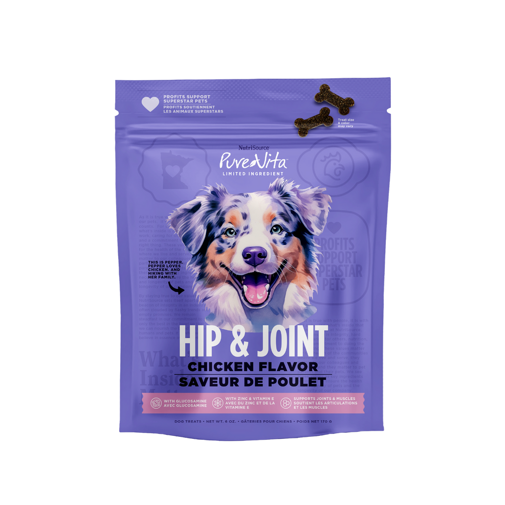 A purple stand-up pouch of PuraVita Hip & Joint Chicken Flavor dog treats, featuring a smiling Australian Shepherd illustration on the front and two dark brown bone-shaped treats shown near the top right.