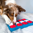 White/Brown dog playing with Outward Hound Dog Brick Interactive Treat Puzzle Dog Toy
