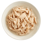 RAWZ Shredded Chicken Breast, Coconut Oil & New Zealand Green Mussels Recipe Canned Dog Food In a white bowl