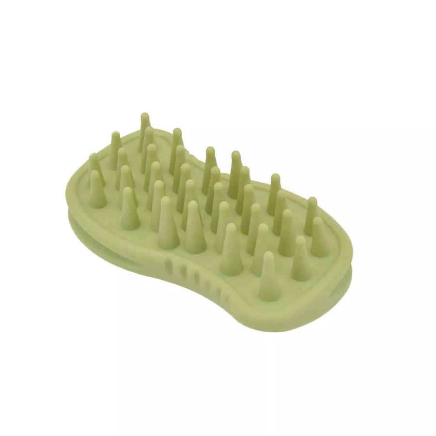 Green palm brush with rounded, rubberized brush teeth. Brush positioned laying down on back. Safari Soft Tip Massager Cat Brush.