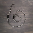 Wilderdog Slip Leash in black and white geometric pattern laid flat on a wooden surface, showing the rope construction, adjustable slip loop, and knotted handle.