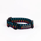 Wilderdog Marina ultralight dog collar looped on white background, showing navy webbing with teal, orange, yellow, and red geometric flame pattern, black D-ring, quick-release buckle, and Wilderdog logo patch.