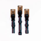 Three Wilderdog Marina ultralight dog collars in Small, Medium, and Large sizes displayed on branded kraft paper hang tags against a white background, showing navy webbing with multicolor geometric pattern.