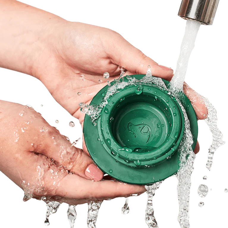 Woof Pupsicle Dog Treat Toy Green washed under a faucet