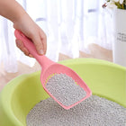 Close-up of the Yiwu Small Hole Cat Litter Scooper in use in a cat litter box.