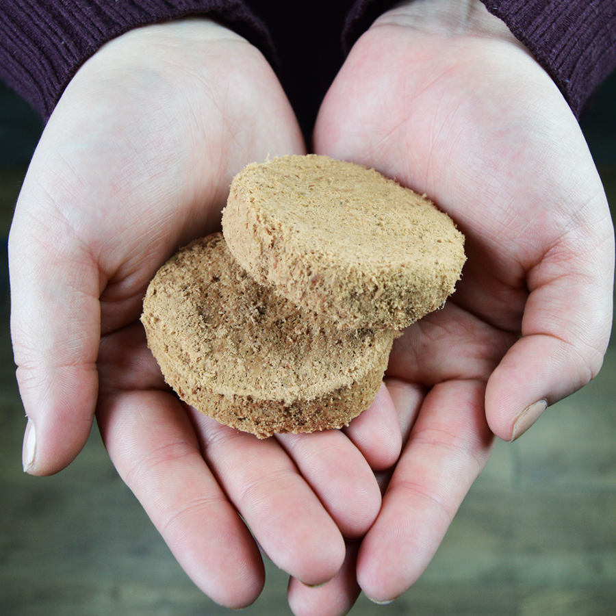 Stella & Chewy's Chewy's Chicken Grain Free Dinner Patties Freeze Dried Raw Dog Food, pieces in hand