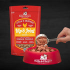 Stella & Chewy's Stella's Solutions Grain Free Hip & Joint Boost Cage Free Chicken Dinner Morsels Freeze-Dried Raw Dog Food, Pouch and in a pet bowl